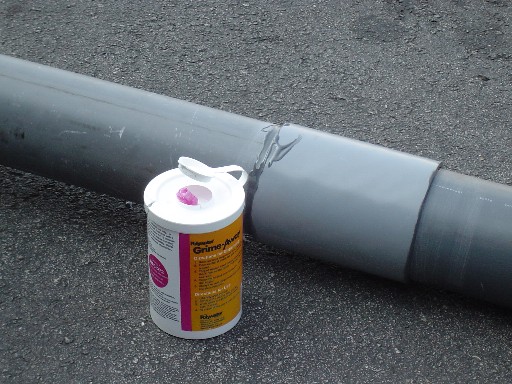 Within mere minutes the PVC coupling is firmly secured to the polyethylene duct. Grime-Away Multipurpose Cleaning Wipes were used to clean excess adhesive from hands and tools. Grime-Away is the best cleaner sold for this purpose.