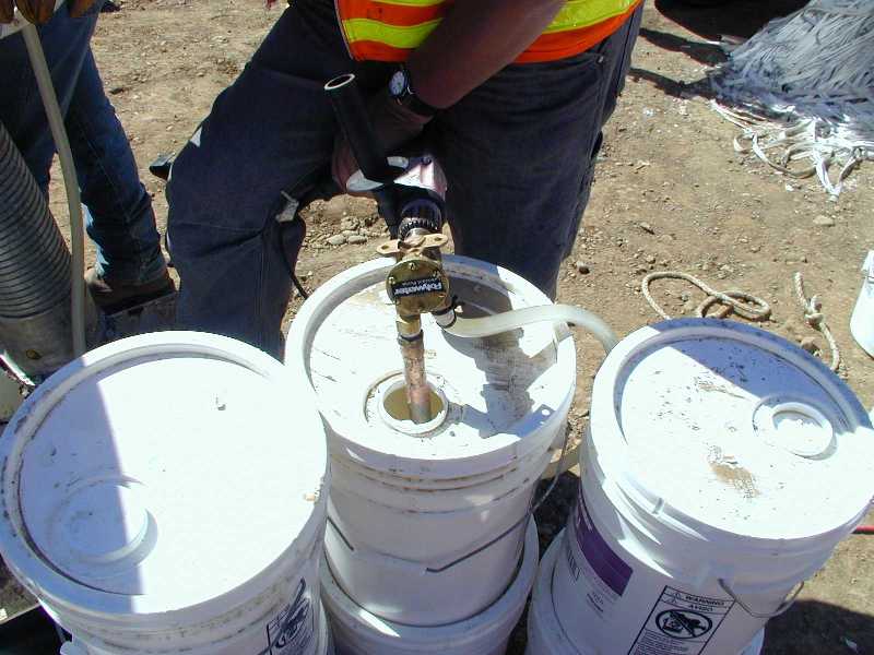 The Polywater® Model LP-D5 feed tube is inserted into a 5-gallon pail or 55-gallon drum
