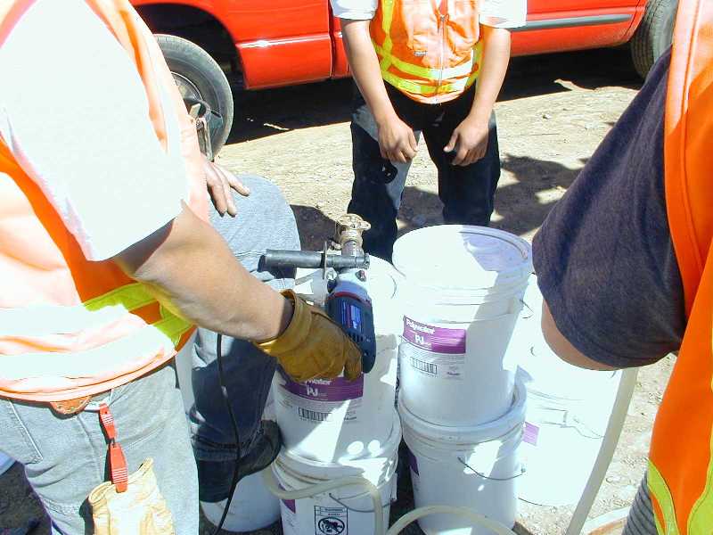 Running the attached drill operates the pump, allowing transfer of lubricant at up to a 1.5-gallon-per-minute rate.